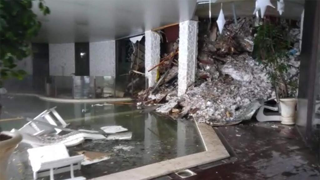 This photo taken from a video shows show piles of snow and rubble cascading down the stairway into the foyer of the hotel Rigopiano in Farindola, Italy, early Thursday, Jan. 19, 2017. A hotel in the mountainous region hit again by quakes has been covered by an avalanche, with reports of dead. Italian media say the avalanche covered the three-story hotel in the central region of Abruzzo, on Wednesday evening. (Italian Finance Police via AP)