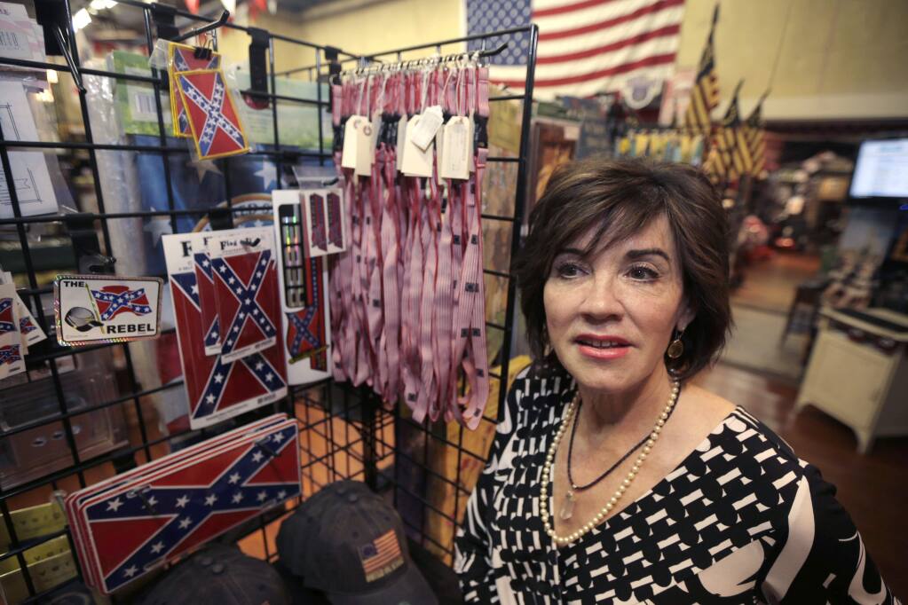Kerry McCoy, owner of Arkansas Flag and Banner in Little Rock, Ark., describes the demand for Confederate flag merchandise Tuesday, June 23, 2015. Major retailers are halting sales of the Confederate flag and related merchandise. (AP Photo/Danny Johnston)