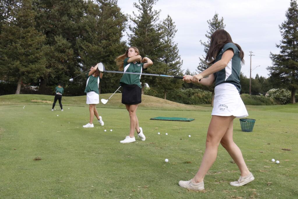 Members of the Sonoma Valley girls golf team - including Samantha Pencil, center - practice their drives at Sonoma Golf Club prior to their match with Napa. (Christian Kallen/Index-Tribune)
