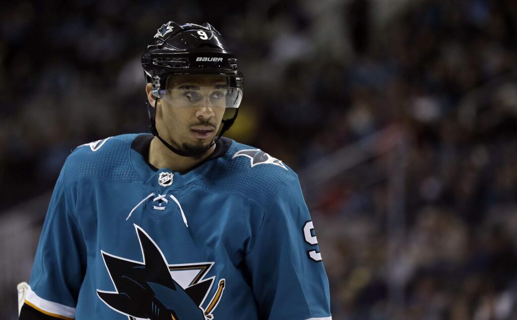 In this March 20, 2018, file photo, the San Jose Sharks' Evander Kane waits for play to resume during the second period of the team's game against the New Jersey Devils in San Jose. The Sharks are closing in on a seven-year contract with Kane that will keep the high-scoring forward off the free-agent market. (AP Photo/Marcio Jose Sanchez, File)