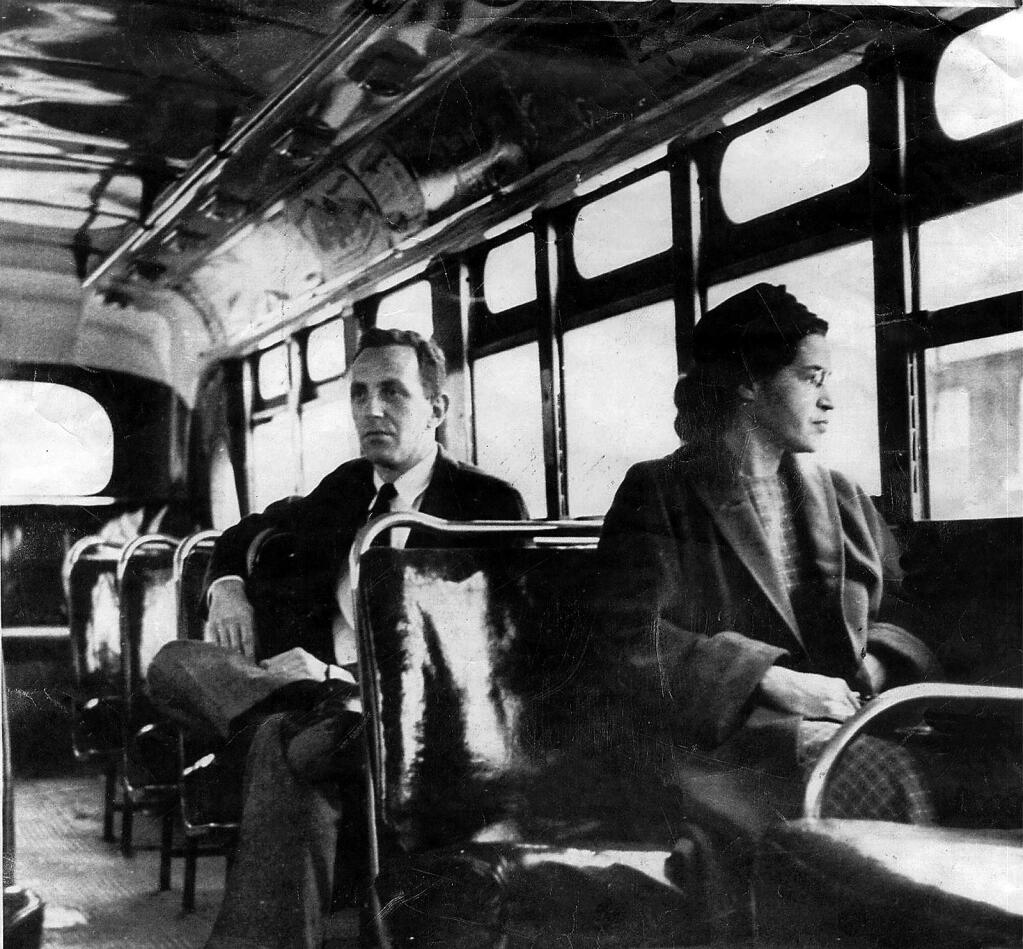 An undated photo shows Rosa Parks riding on the Montgomery Area Transit System bus in Montgomery, Ala. Parks refused to give up her seat on a Montgomery bus on Dec. 1, 1955, igniting the boycott that led to a federal court ruling against segregation in public transportation. (DAILY ADVERTISER / via AP)