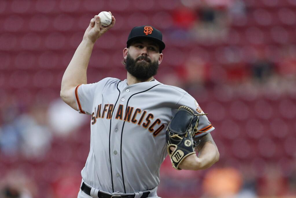 San Francisco Giants starting pitcher Casey Kelly throws against the Cincinnati Reds during the first inning Friday, Aug. 17, 2018, in Cincinnati. (AP Photo/Gary Landers)