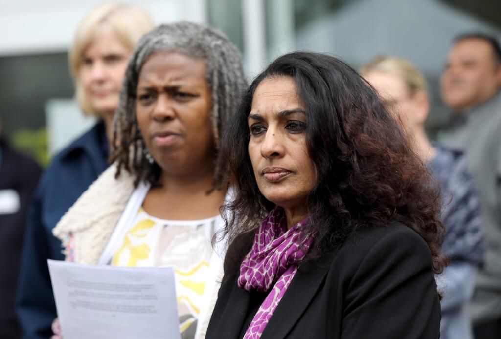 Dr. Sundari Mase, Sonoma County health officer, right, and Barbie Robinson, the health services director, left, attend a press conference about the first community spread case of the coronavirus and the local response. Photo taken outside the Sonoma County administration building in Santa Rosa on Sunday, March 15, 2020. (Beth Schlanker / The Press Democrat)