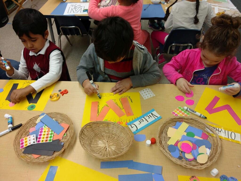 Students in Sassarini's preschool inclusion classroom busy with phonetic art projects.