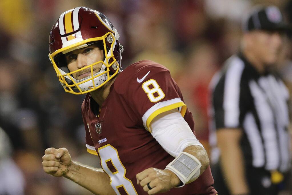 Washington Redskins quarterback Kirk Cousins celebrates his touchdown pass to tight end Vernon Davis during the first half of a game against the Oakland Raiders in Landover, Maryland, Sunday, Sept. 24, 2017. (AP Photo/Mark Tenally)