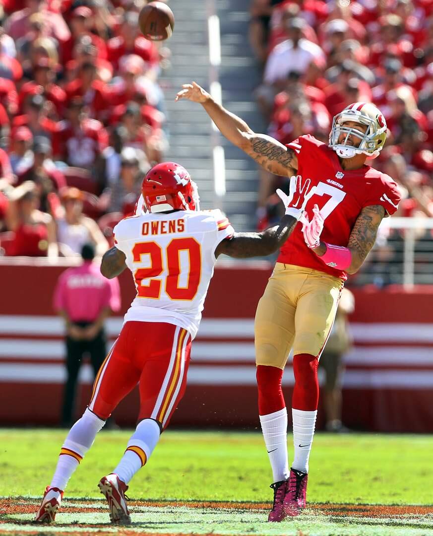 San Francisco 49ers starting quarterback Colin Kaepernick gets the ball away under pressure from Chris Owens. Photo by John Burgess/The Press Democrat
