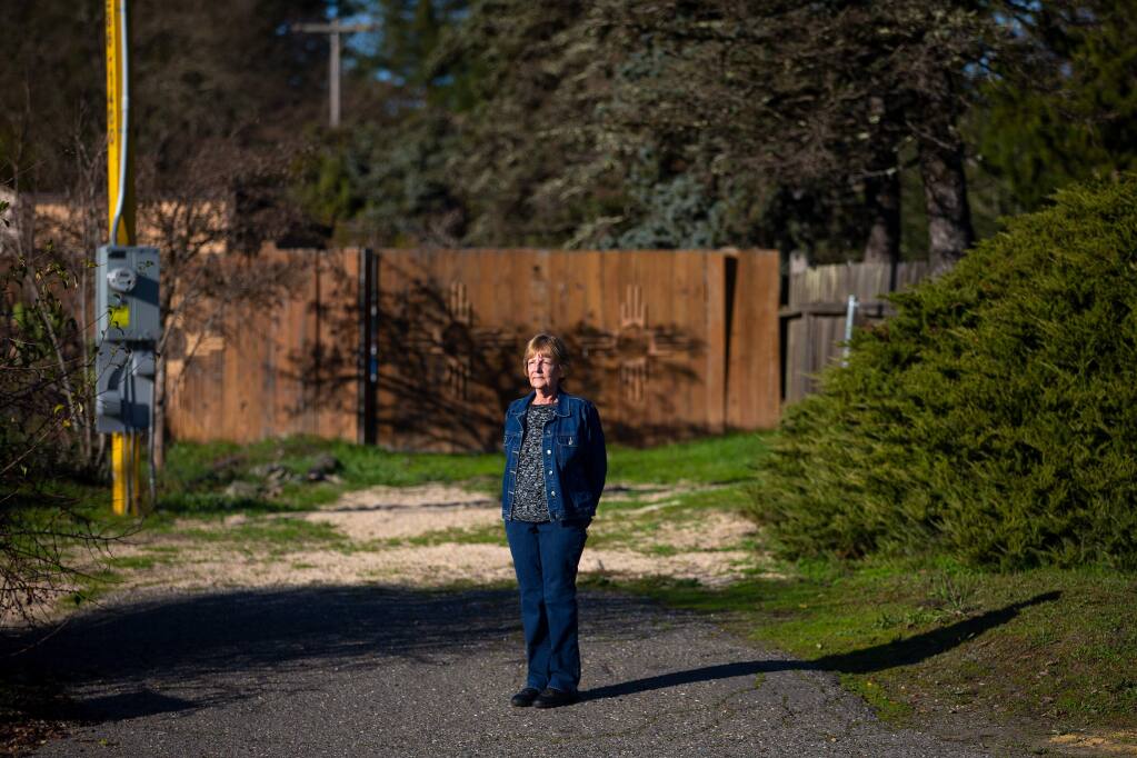 Charlene Flowers, a resident of Blue Spruce Lodge senior community, stands in the driveway where the Graton Community Services District has proposed to install a sewage receiving station that will be next door to Flowers' neighborhood in Sebastopol, California, on Wednesday, January 22, 2020. (Alvin Jornada / The Press Democrat)