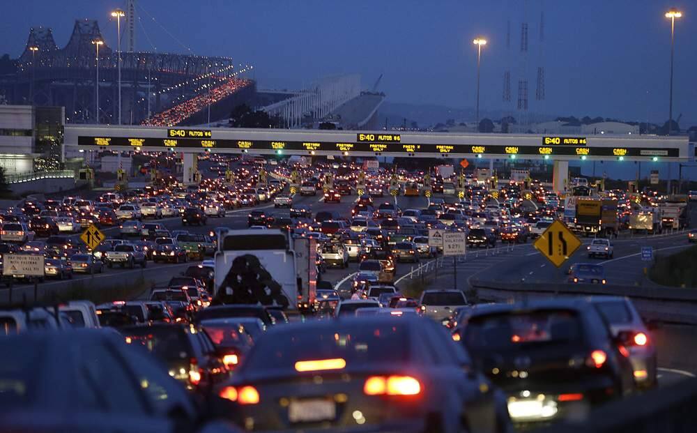 In this file photo from Monday, July 1, 2013, commuters wait in standstill traffic to pay their tolls on the San Francisco-Oakland Bay Bridge in Oakland, Calif. San Francisco Bay Area commuters braced for the possibility of another train strike as the Bay Area Rapid Transit agency and its workers approached a deadline to reach a new contract deal. The two sides were set to resume negotiations at noon on Thursday, Aug. 1, but did not appear close to an agreement. (AP Photo/Ben Margot)