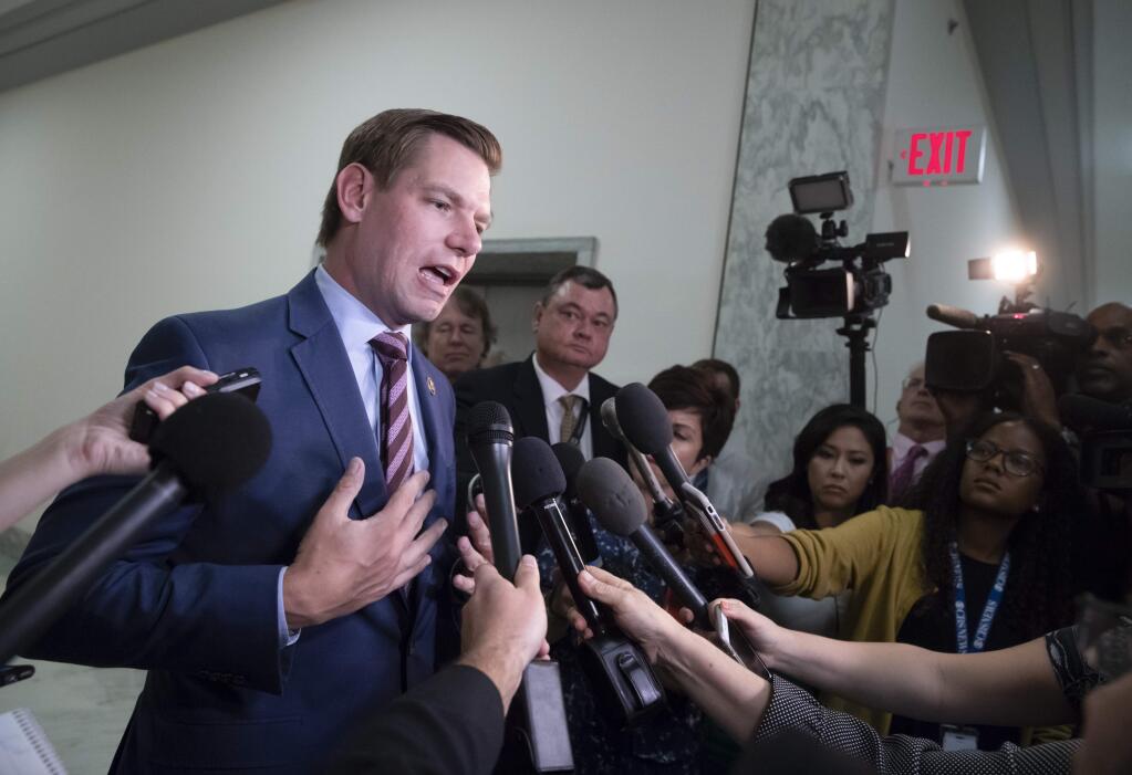 Rep. Eric Swalwell, D-Calif., pauses to speak with reporters as former FBI lawyer Lisa Page is questioned behind closed doors by members of the House Judiciary Committee and House Oversight Committee on whether political bias affected the investigations of Hillary Clinton's emails and the Trump campaign's alleged ties to Russia, on Capitol Hill in Washington, Monday, July 16, 2018. (AP Photo/J. Scott Applewhite)