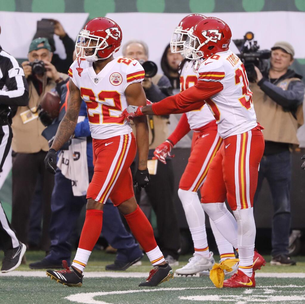 Teammates of Kansas City Chiefs' Marcus Peters, left, try to prevent him from leaving the field after a penalty during the second half against the New York Jets, Sunday, Dec. 3, 2017, in East Rutherford, N.J. (AP Photo/Julie Jacobson)