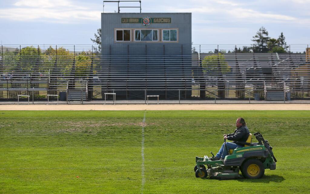 Jim Whitt mows the grass on the football field at Casa Grande High School, in Petaluma on Thursday, May 7, 2015. The irrigation at the school is controlled and monitored using technology by HydroPoint Data Sytems to save water. (Christopher Chung/ The Press Democrat)