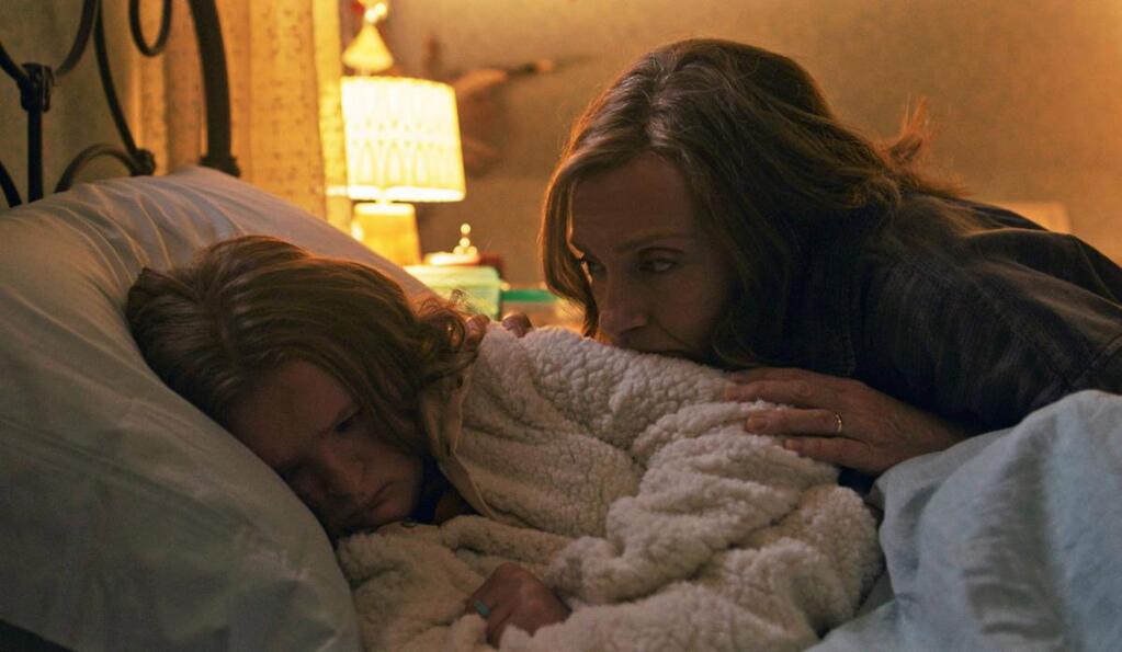 Milly Shapiro, left, as Charlie Graham and Toni Collette as Annie Graham, an artist whose family begins to unravel after the family matriarch dies and the increasingly terrifying secrets about their ancestry become known in 'Heredity.' (A24)