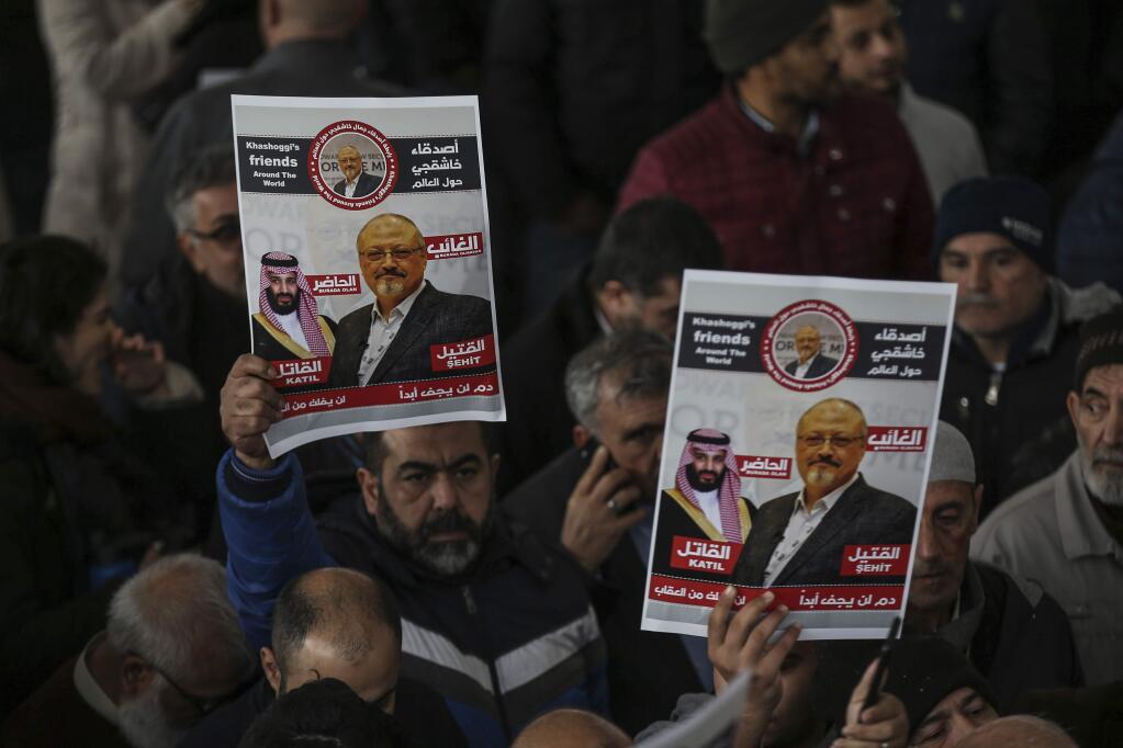The members of Arab-Turkish Media Association and friends hold posters as they attend funeral prayers in absentia for Saudi writer Jamal Khashoggi who was killed last month in the Saudi Arabia consulate, in Istanbul, Friday, Nov. 16, 2018. Turkey's Foreign Minister Mevlut Cavusoglu on Thursday called for an international investigation into the killing of the Saudi dissident writer Jamal Khashoggi.(AP Photo/Emrah Gurel)