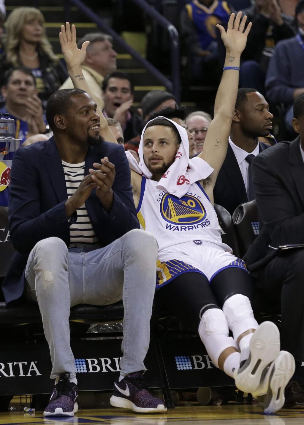 Golden State Warriors' Kevin Durant, left, and Stephen Curry celebrate a score against the Sacramento Kings during the second half Friday, March 24, 2017, in Oakland. (AP Photo/Ben Margot)