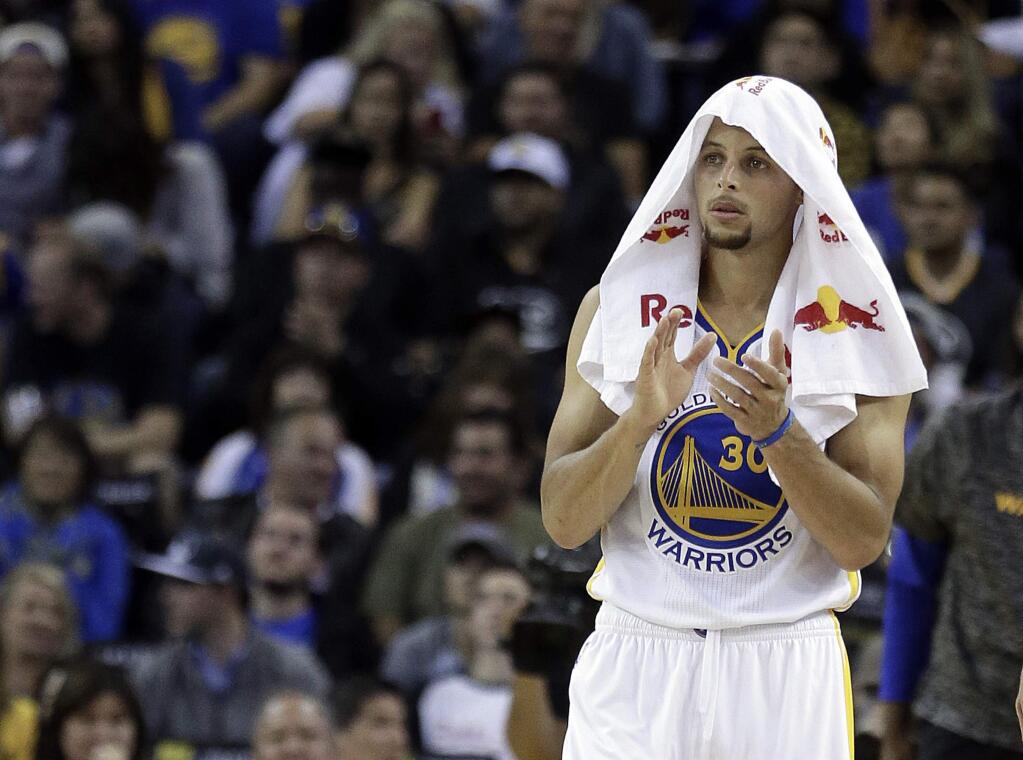 Golden State Warriors' Stephen Curry applauds during a timeout in the second half of the team's preseason NBA basketball game against the Portland Trail Blazers on Friday, Oct. 21, 2016, in Oakland, Calif. (AP Photo/Ben Margot)
