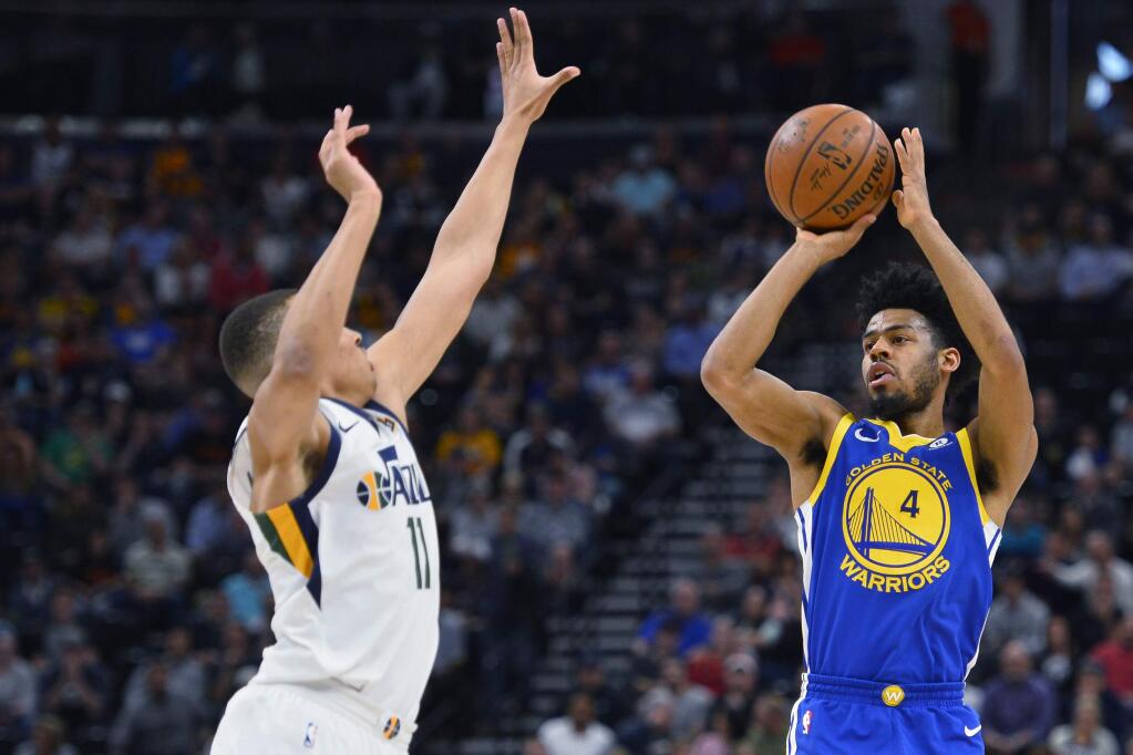 Golden State Warriors guard Quinn Cook, right, shoots over Utah Jazz guard Dante Exum in the first half Tuesday, April 10, 2018, in Salt Lake City. (AP Photo/Alex Goodlett)