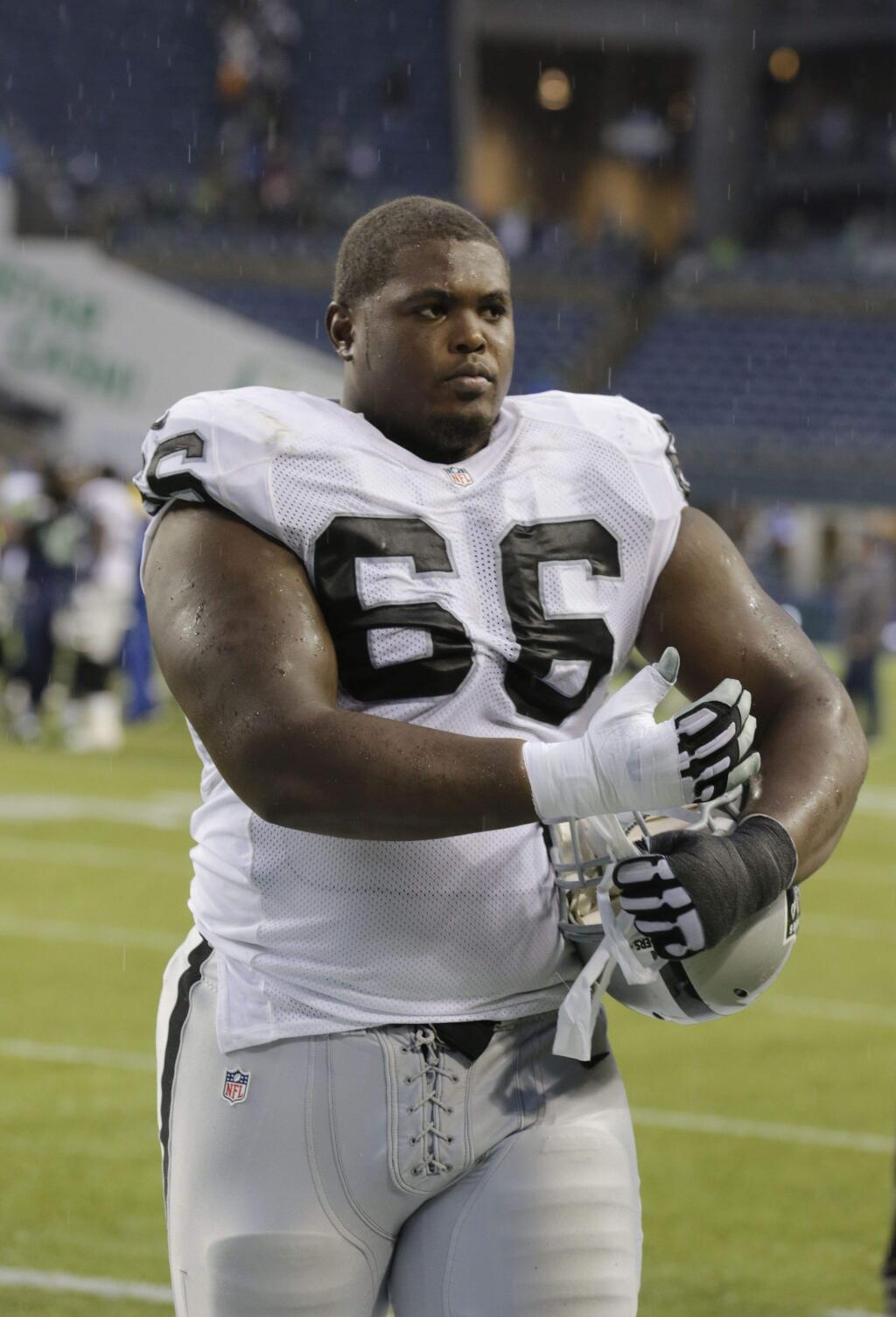 Oakland Raiders guard Gabe Jackson walks off the field after a game against the Seattle Seahawks, Sunday, Nov. 2, 2014, in Seattle. (AP Photo/Stephen Brashear)