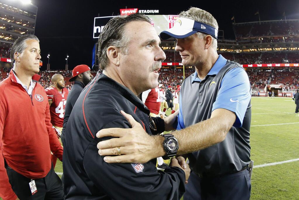 San Francisco 49ers head coach Jim Tomsula, center left, greets San Diego Chargers head coach Mike McCoy after a game in Santa Clara, Thursday, Sept. 3, 2015. The 49ers won 14-12. (AP Photo/Tony Avelar)