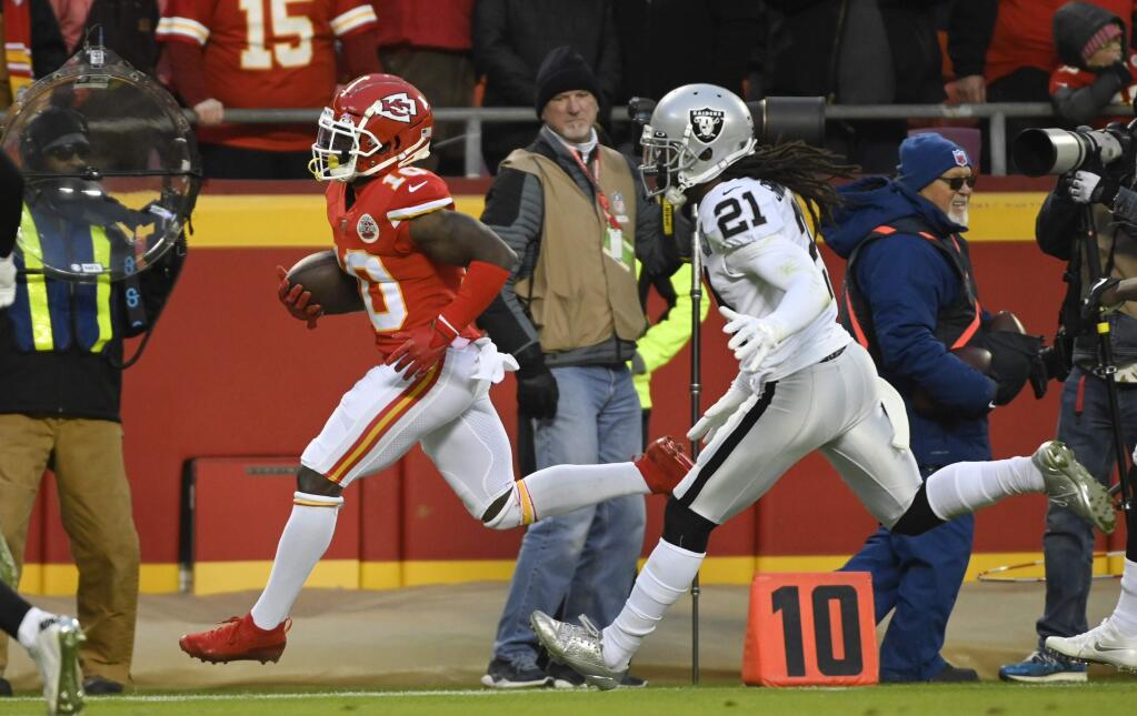 Kansas City Chiefs wide receiver Tyreek Hill is forced out of bounds by Oakland Raiders free safety D.J. Swearinger during the first half in Kansas City, Mo., Sunday, Dec. 1, 2019. (AP Photo/Reed Hoffmann)