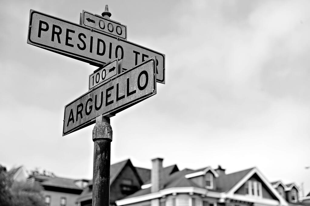 FILE - In this Aug. 7, 2017 file photo, street signs are seen at the intersection of Presidio Terrace and Arguello at the entrance to the Presidio Terrace neighborhood in San Francisco. Wealthy homeowners whose private, gated and very exclusive San Francisco street was auctioned off after decades of unpaid taxes are asking supervisors Monday, Nov. 27, 2017, to undo the sale, prompting cries of elitism in a city obsessed with property and fairness. (AP Photo/Marcio Jose Sanchez, File)