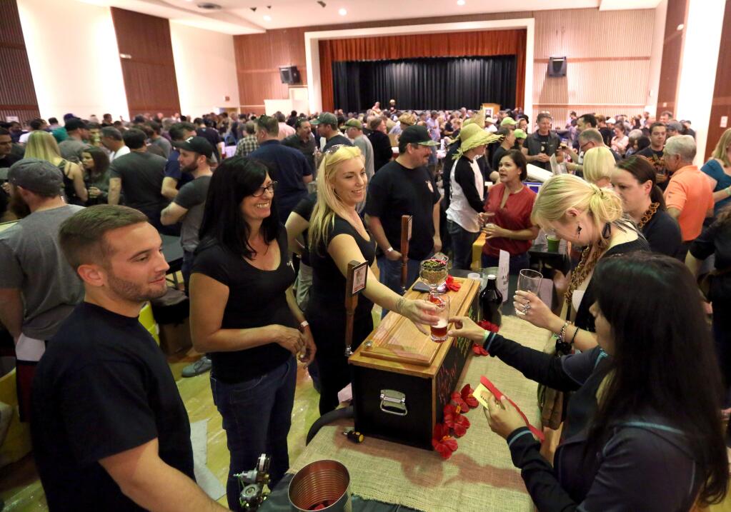 Turkey Trail Brewing Company from left to right, Zack Wansor, Noreen Espinda and Rachel Olson serve beer during the Sonoma County Home Brewer's Competition held at Petaluma's Veterans Memorial Building, Saturday, May 23, 2015. (CRISTA JEREMIASON / The Press Democrat)