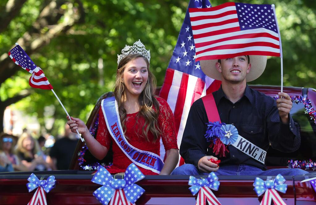 The queen and king of the Kenwood 4th of July Hometown Parade, Allie Ahern, left, and Dominic Amantite, wave to the crowd, in Kenwood, on Monday, July 4, 2016. (Christopher Chung/ The Press Democrat)