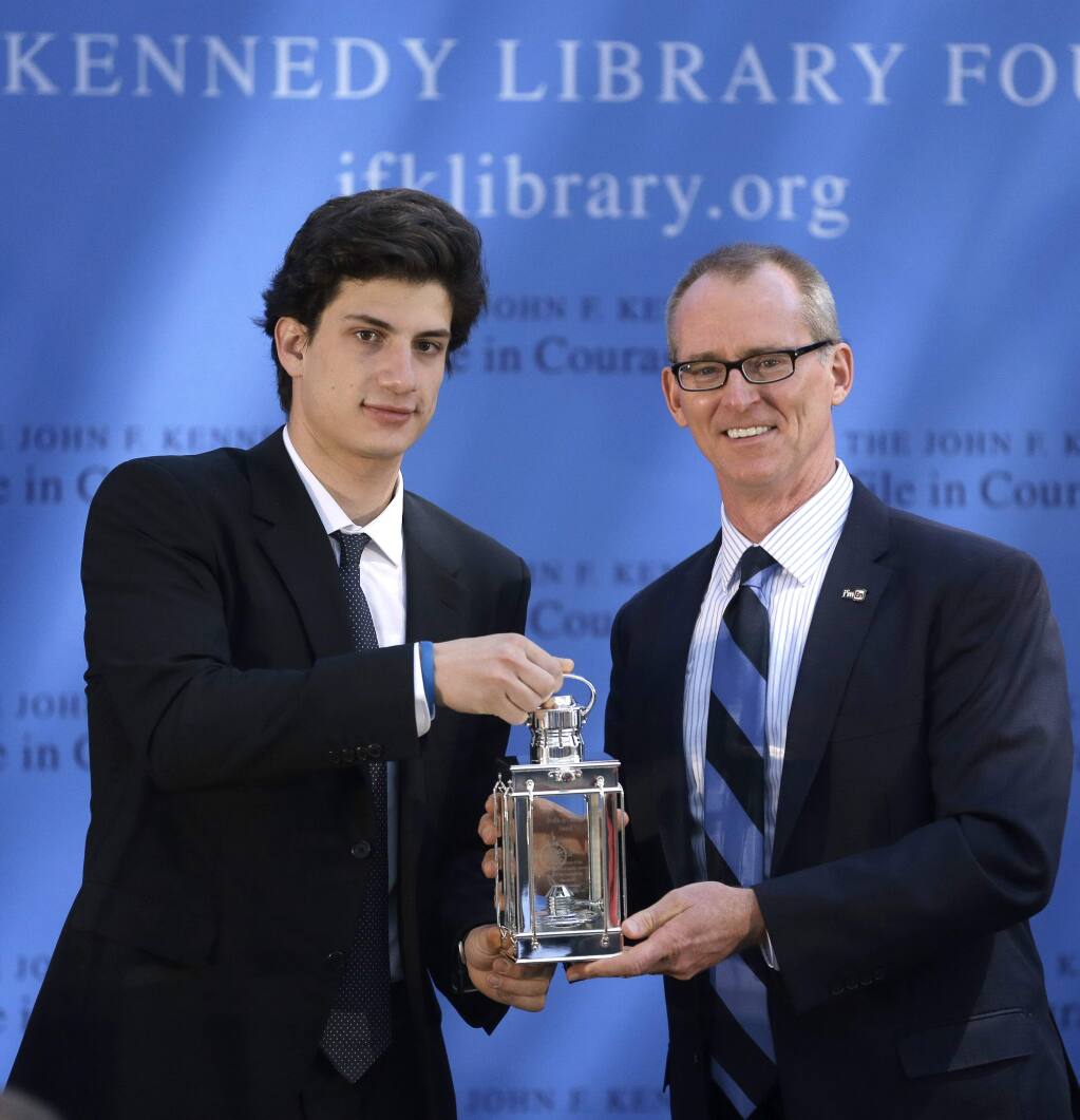 Jack Schlossberg, left, grandson of for President John F. Kennedy, presents former U.S Rep. Bob Inglis, R-S.C., right, with the 2015 Profile in Courage Award, at the John F. Kennedy Library and Museum, Sunday, May 3, 2015, in Boston. Inglis was awarded the prize for reversing his position on climate change. (AP Photo/Steven Senne)