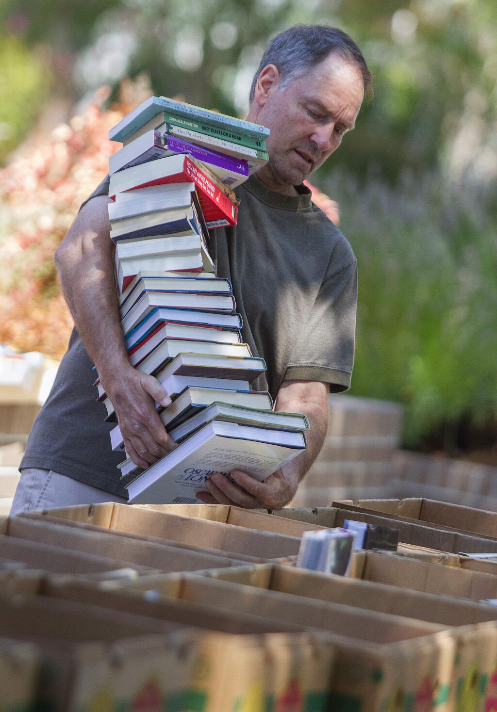 Robbi Pengelly/Index-TribuneA balancing actBrian Newick, a master of book balancing, has his hands full at the Friends of the Sonoma Valley Library's August book sale, last weekend at the Sonoma Valley Regional Library. The sale brought in almost $12,000. All book donations not sold (including those not put out for the sale) at the sale end up going to St. Vincent de Paul, so all donations get to someone.