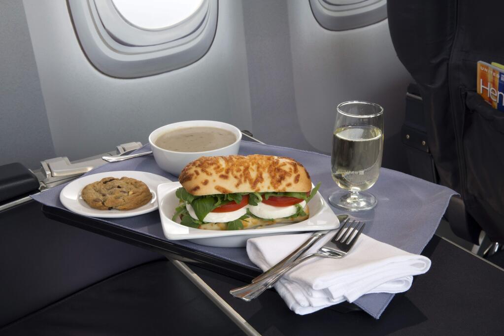 This product image provided by United Airlines shows a Caprese on Asiago Baguette sandwich, one of a variety of the airline's new first class food options. The Chicago-based airline on Thursday, Aug. 21, 2014 announced that it is upgrading first class food options and replacing snacks with full meals on some of its shortest flights. (AP Photo/United Airlines)