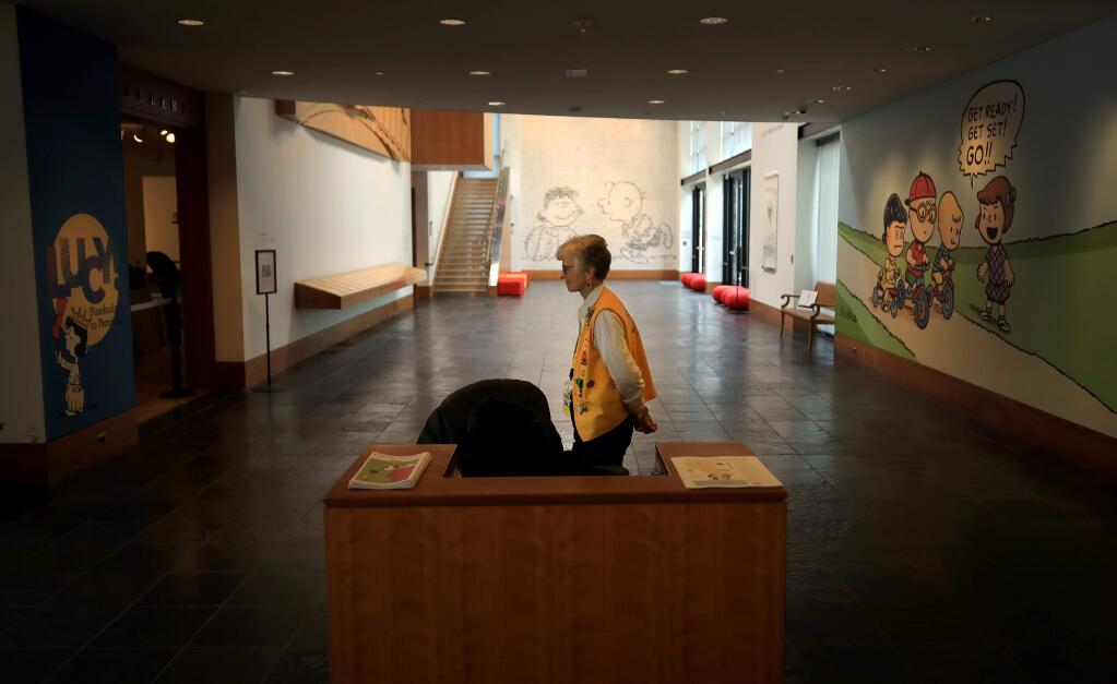 At the Charles M. Schulz Museum in Santa Rosa, volunteer docent Kay Pugh silently paces as she waits to inform visitors to the museum about the history of Peanuts characters, Friday, March 13, 2020. Attendance at the museum is down due to COVID-19.(Kent Porter / The Press Democrat) 2020