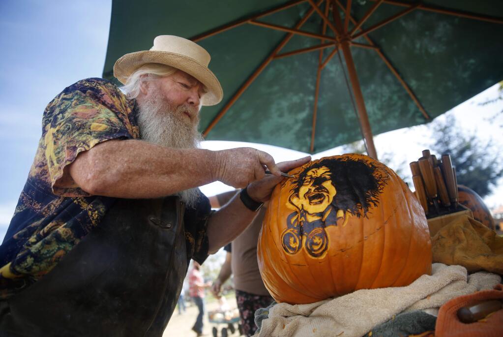Jason Todd carves Gene Wilder from the movie Young Frankenstein onto a pumpkin at Muelrath Ranches pumpkin patch on Sunday, October 23, 2016 in Santa Rosa, California . (BETH SCHLANKER/ The Press Democrat)