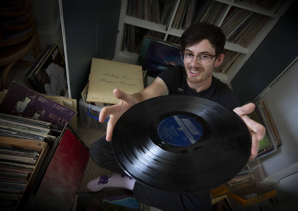 Jack Allan examines a vintage vinyl LP record in his home in Boyes Hot Springs on Thursday, May 18, 2023. (Robbi Pengelly/Index-Tribune)