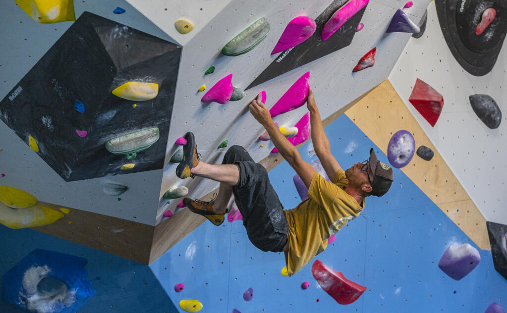 Climber Lucas Hill works to solve a climbing problem on June 23, 2022, at Session climbing gym in Santa Rosa during a soft launch of the facility.  (Chad Surmick / The Press Democrat)