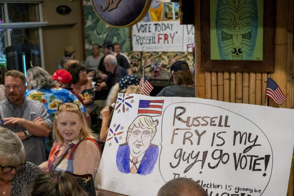 Supporters celebrate South Carolina Rep. Russell Fry's win over U.S. Rep. Tom Rice for his congressional seat in the Republican primary, at the 8th Avenue Tiki Bar in Myrtle Beach, S.C., Tuesday, June 14, 2022.  (Jason Lee/The Sun News via AP)