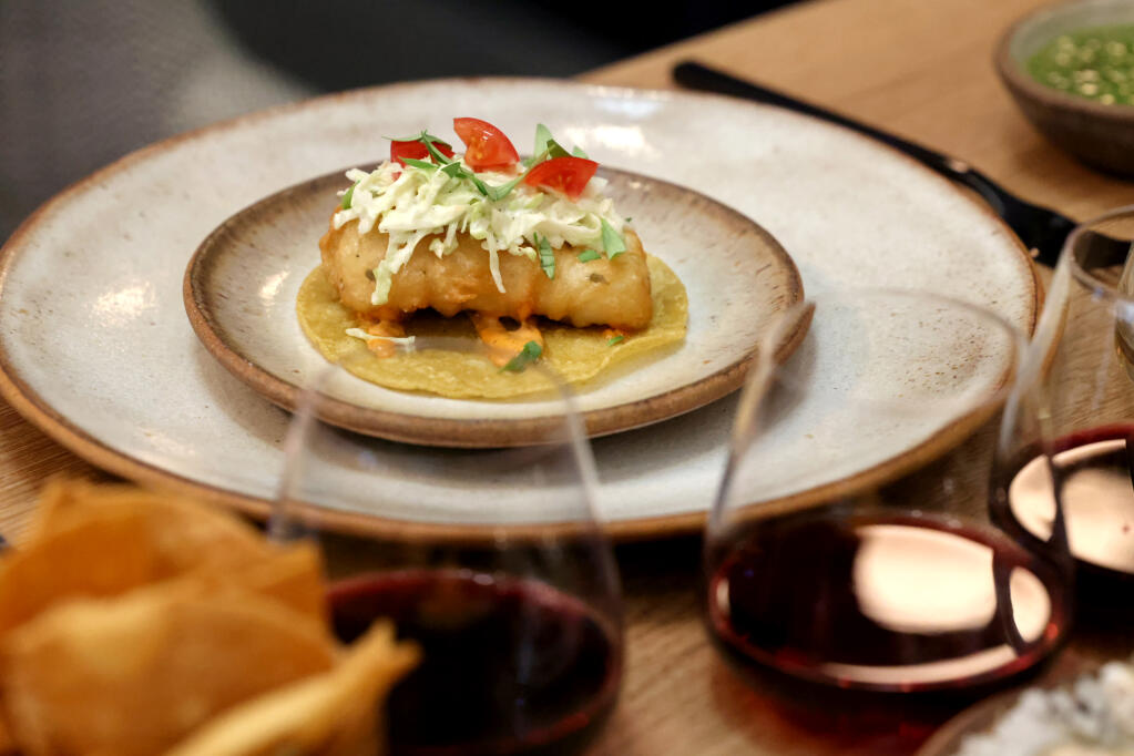 An Alaskan halibut fish taco with cabbage slaw and homemade chipotle sauce on a corn tortilla is served at the Saldo Salon at The Prisoner Winery Co. in St. Helena, Thursday, Oct. 19, 2023. (Beth Schlanker / The Press Democrat)