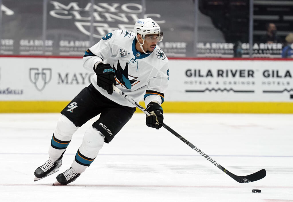 In this March 26, 2021, file photo, San Jose Sharks left wing Evander Kane moves the puck during the team’s game against the Arizona Coyotes in Glendale, Arizona. The NHL says it will investigate an allegation made by Kane’s wife that he bets on his own games and has intentionally tried to lose for gambling profit. (/Rick Scuteri / ASSOCIATED PRESS)