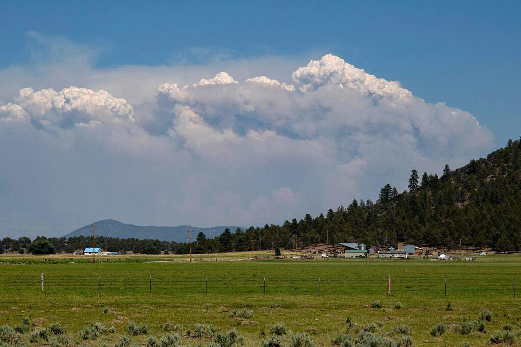 In this photo provided by the Bootleg Fire Incident Command, columns of smoke rise from the Bootleg fire in southern Oregon on Sunday, July 18, 2021. (Bootleg Fire Incident Command via AP)