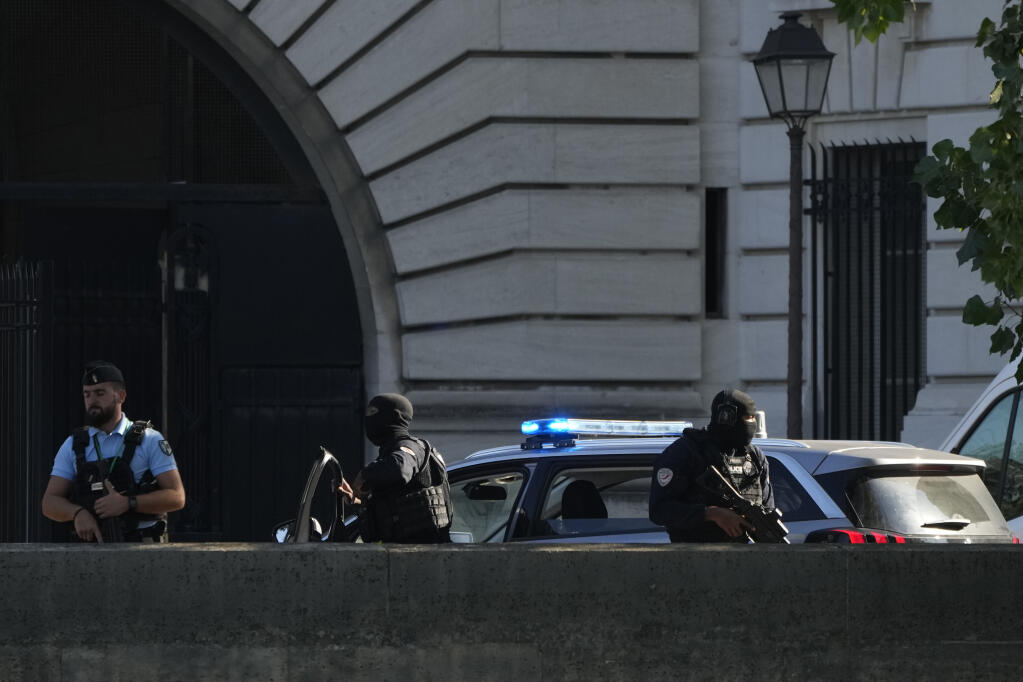 Security forces guard an entrance of the Palace of Justice Wednesday, Sept. 8, 2021 in Paris. (AP Photo/Francois Mori)