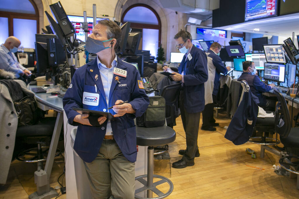 Traders work on the New York Stock Exchange floor in New York, Tuesday, Jan. 25, 2022. Stocks are closing lower on Wall Street Tuesday after another volatile day of trading. Technology companies like Microsoft were again the biggest drag on the market. (AP Photo/Ted Shaffrey)