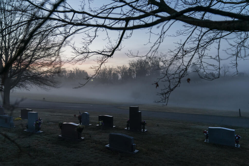 FILE - In this Wednesday, March 17, 2021 file photo, morning fog blankets a cemetery in West Virginia. The number of U.S. suicides fell nearly 6% in 2020 amid the coronavirus pandemic — the largest annual decline in at least four decades, according to preliminary government data. (AP Photo/David Goldman)