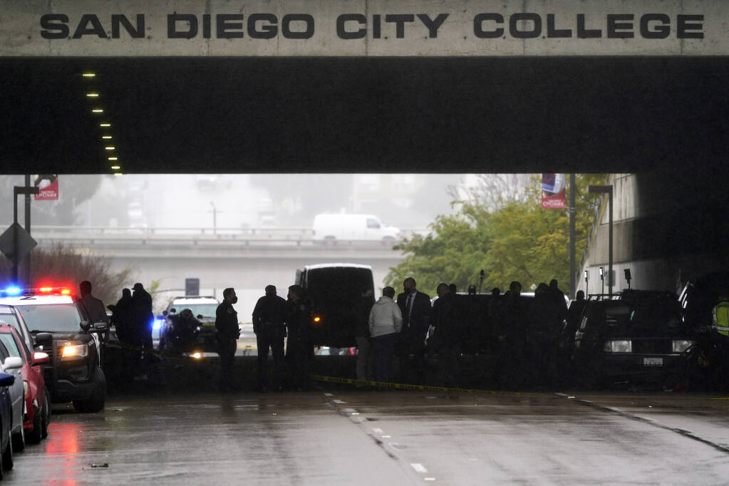 Emergency crews work at the scene of a deadly accident Monday, March 15, 2021, in San Diego. A driver plowed through a crowd on a sidewalk in downtown San Diego on Monday morning, killing three people and injuring six others, including two who are hospitalized in critical condition, police said. (AP Photo/Gregory Bull)