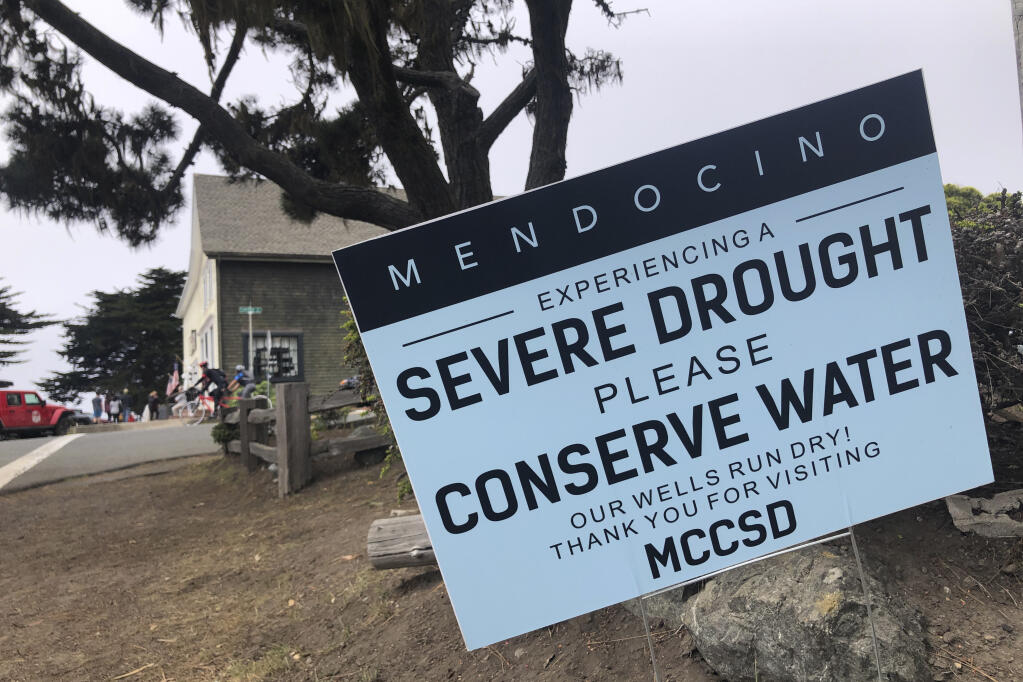 FILE - A sign alerts visitors to the severe drought in Mendocino, Calif., on Aug. 4, 2021. Nearly all Californians may be asked to further cut back on their water use, state officials said Monday, March 28, 2022, as they warned "water scarcity" will shape the future of the nation's most populous state. (AP Photo/Haven Daley, File)