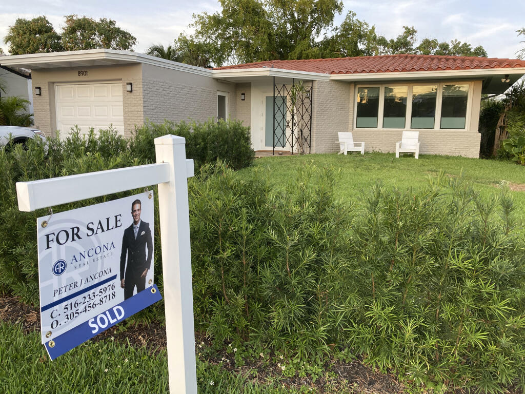 A home with a "Sold" sign is shown, Sunday, May 2, 2021, in Surfside, Fla.  Average long-term U.S. mortgage rates inched up this week following last week’s mammoth jump, the biggest in 35 years. Mortgage buyer Freddie Mac reported Thursday, June 23, 2022,  that the 30-year rate ticked up to 5.81% this week, from last week’s 5.78%.  (AP Photo/Wilfredo Lee, File)