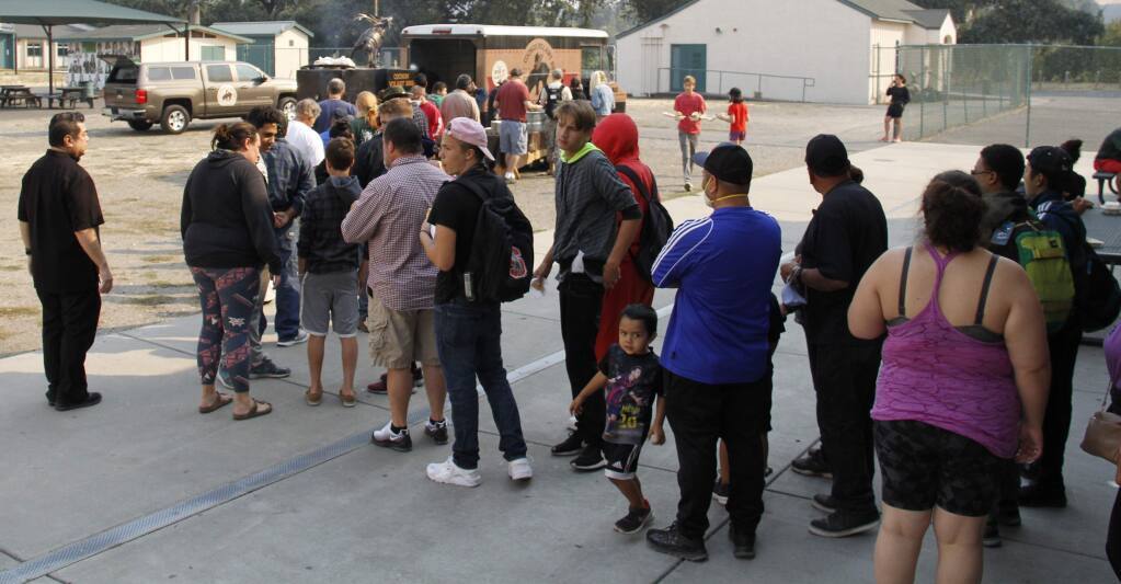 Evacuees of the 2017 wildfires await sustenance from a food truck at Sonoma Valley High School. Today, the Sonoma Community Center and other local agencies are forming a coalition to ready trained volunteers in advance of future emergencies. (Index-Tribune)