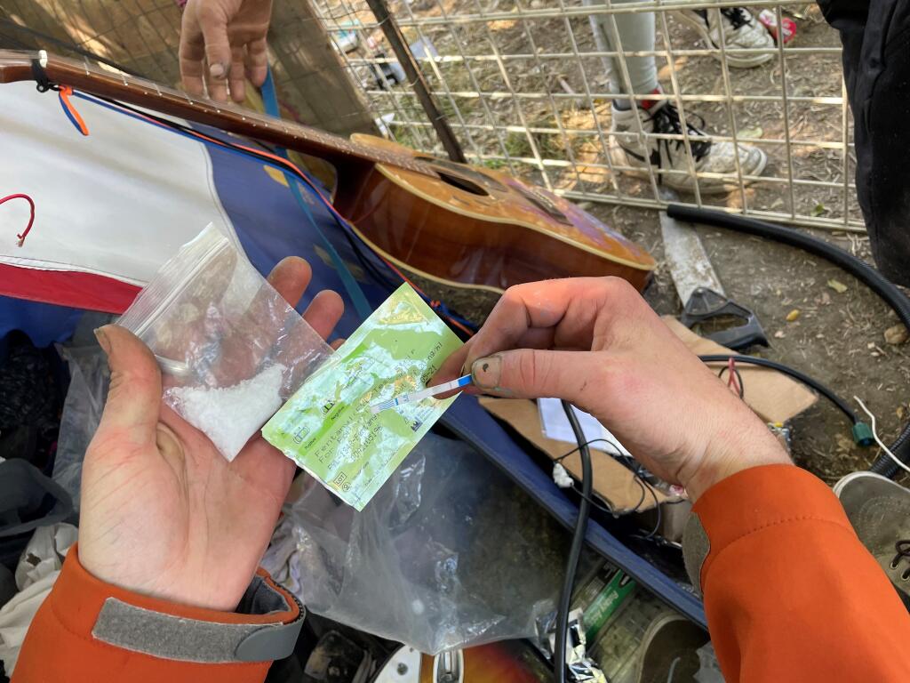 An unhoused Petaluma resident uses a fentanyl testing strip on their meth near the Petaluma River. The testing strip came back positive for fentanyl. Ninety percent of pills and powdered drugs test positive for fentanyl in Sonoma County. (Chase Hunter / Sonoma Index-Tribune)