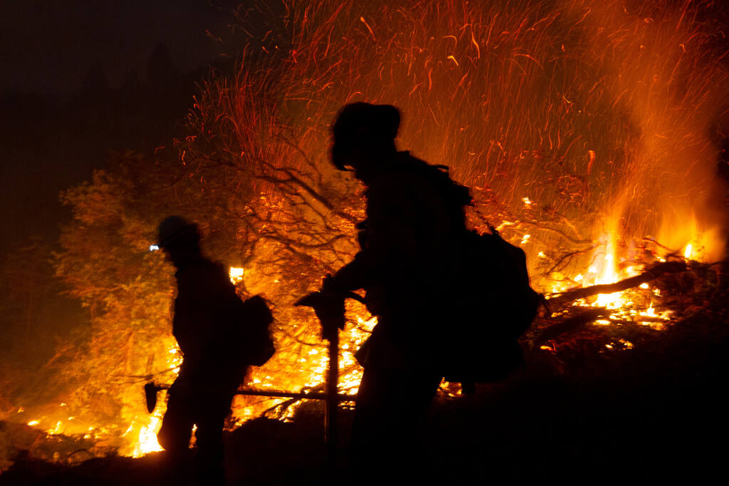 Cal Fire inmate firefighters walk along a fire break during a defensive firing operation in the hills of Sugarloaf Ridge State Park during the Glass fire in Kenwood, California, on Tuesday, Sept. 29, 2020. (Alvin A.H. Jornada / The Press Democrat)