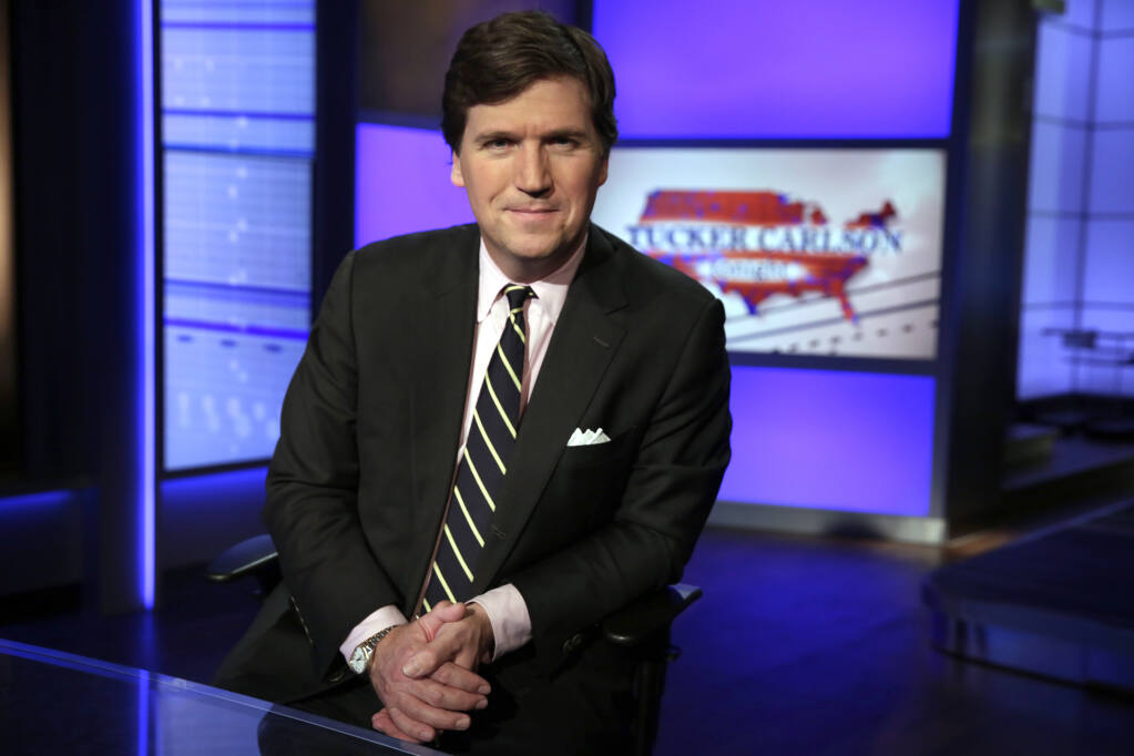 FILE - In this March 2, 20217, file photo, Tucker Carlson, host of "Tucker Carlson Tonight," poses for photos in a Fox News Channel studio in New York. (AP Photo/Richard Drew, File)