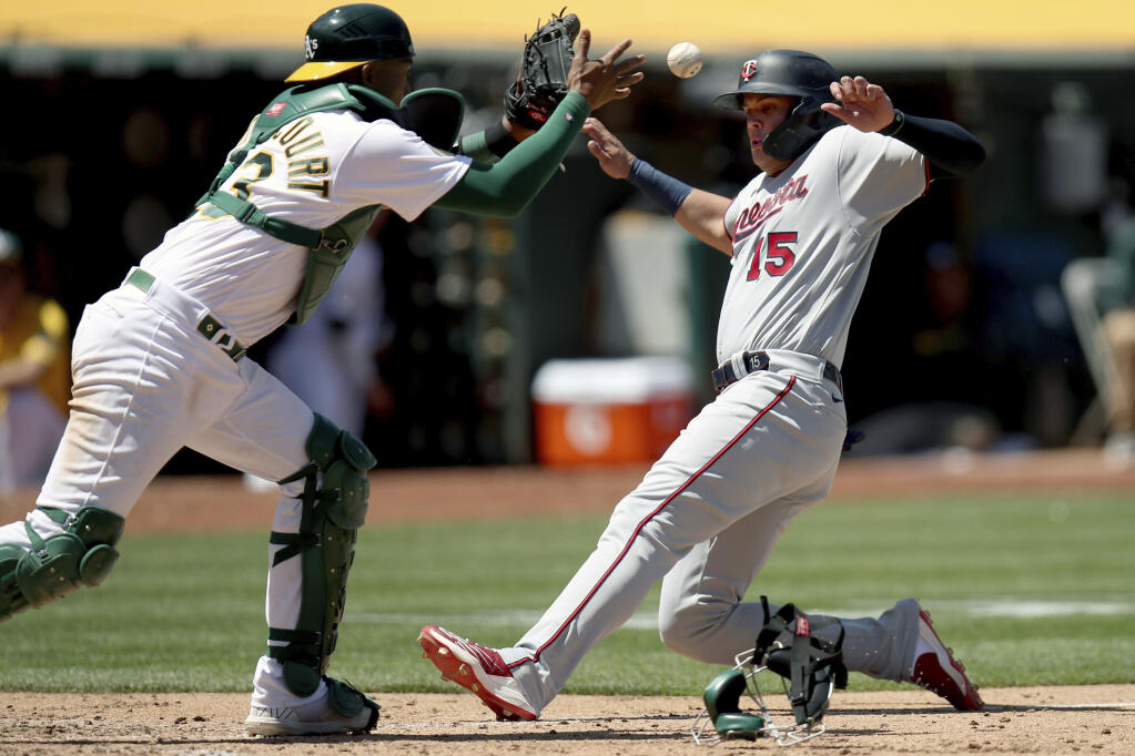 The Athletics’ Luis Barrera forces the Minnesota Twins’ Gio Urshela out at home plate in the fifth inning in Oakland on Wednesday, May 18, 2022. (Scot Tucker / ASSOCIATED PRESS)