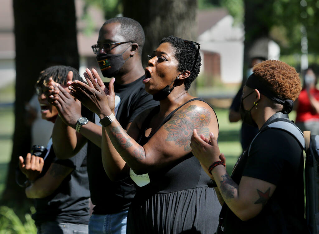Student adviser Regina Mahiri, claps alongside other faculty and staff during a "Blackout" demonstration in the front lawn of Santa Rosa Junior College in Santa Rosa, Calif., on Wednesday, May 5, 2021. (Beth Schlanker/ The Press Democrat)