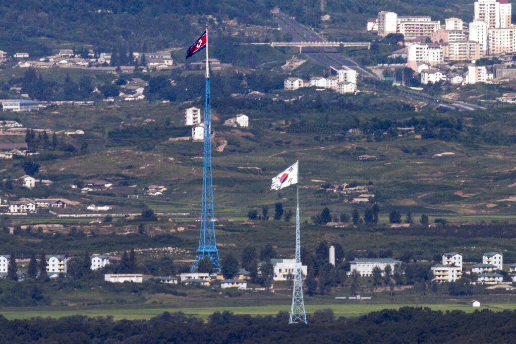 FILE - Flags of North Korea, rear, and South Korea, front, flutter in the wind as pictured from the border area between two Koreas in Paju, South Korea, on Aug. 9, 2021. South Korea’s Joint Chiefs of Staff said North Korea fired a ballistic missile toward its eastern waters Friday, Dec. 23, 2022. (Im Byung-shik/Yonhap via AP, File)